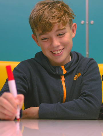 Student writing onto a whiteboard