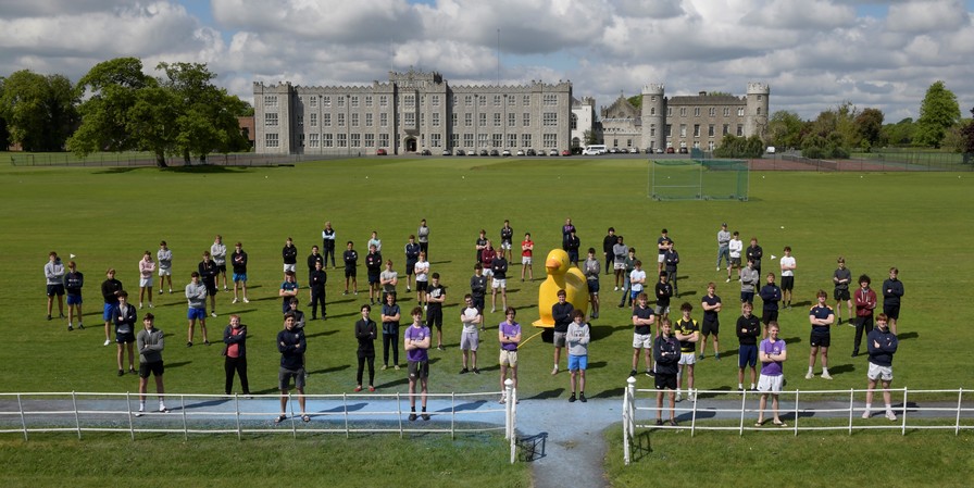 students standing spaced out on a pitch