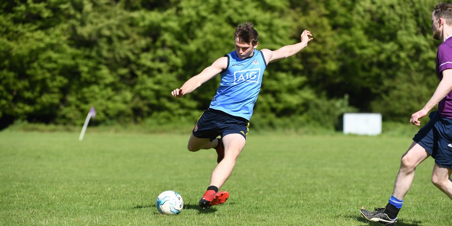 boy kicking ball on a pitch