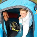 2 boys in a camping tent