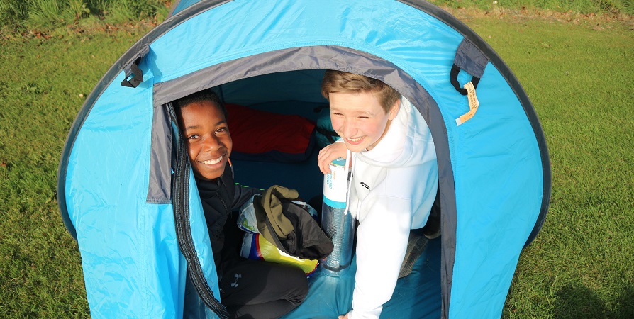 2 boys in a camping tent