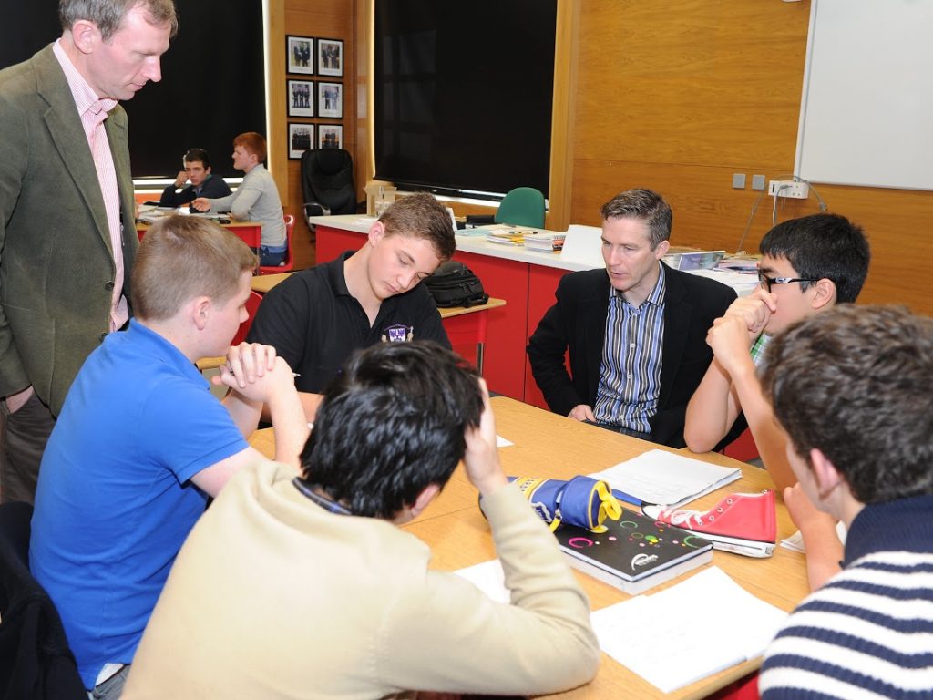 group of students and teachers gathered around a table