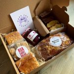 cardboard box full of cake and jam