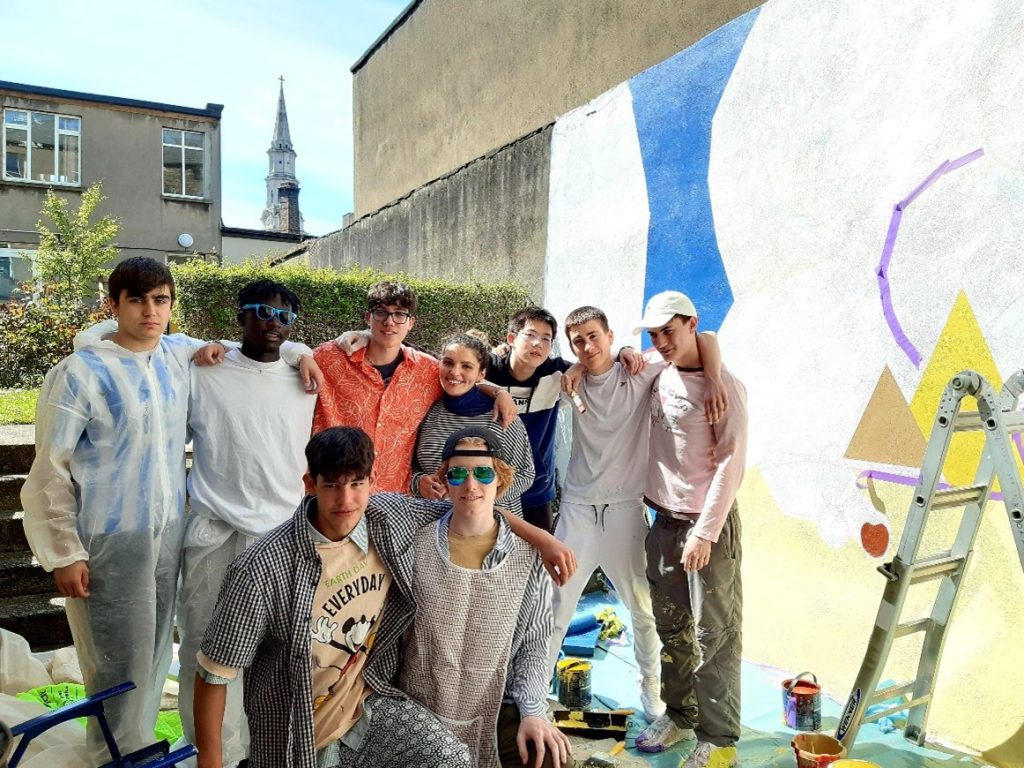students painting a mural