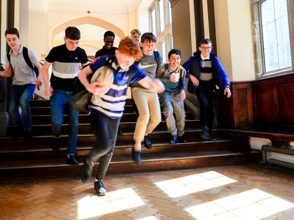 Students running down the stairs