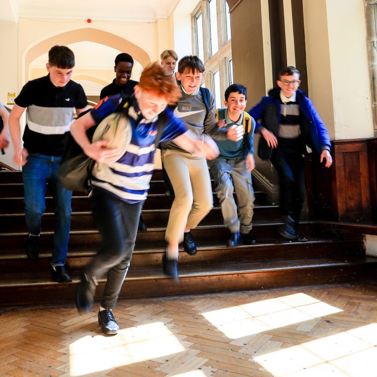 Students running down the stairs